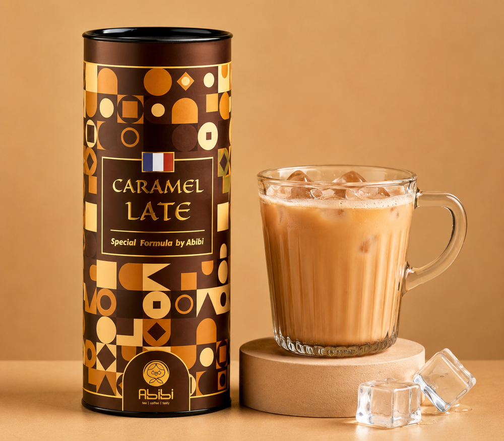 Caramel latte in a glass mug with a decorative canister on a beige background