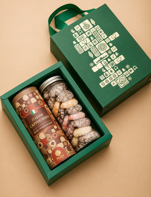 Green gift box with Italian Cappuccino can and assorted candies on a beige background